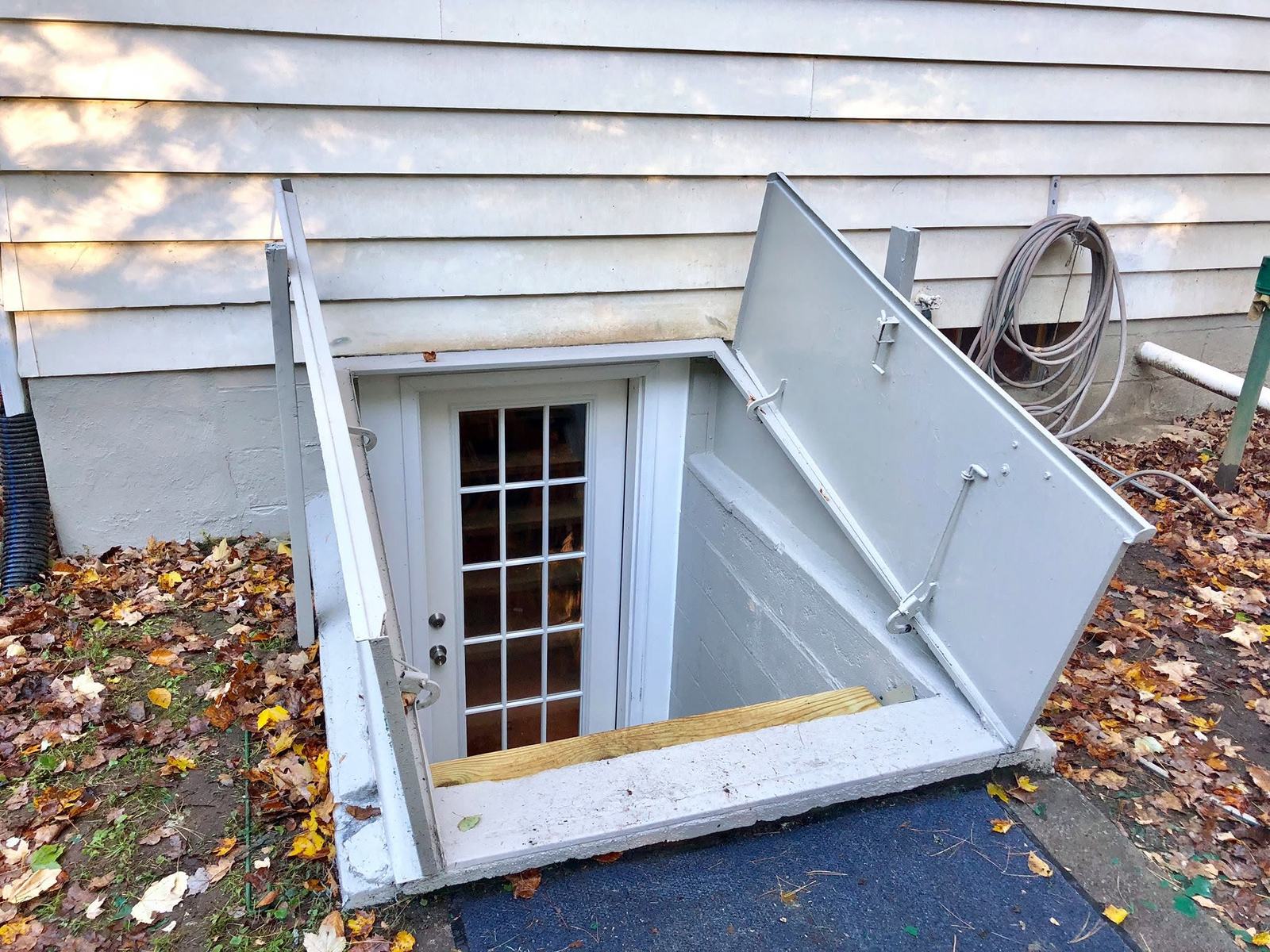 New white bulkhead with the hatch open and a glazed door below