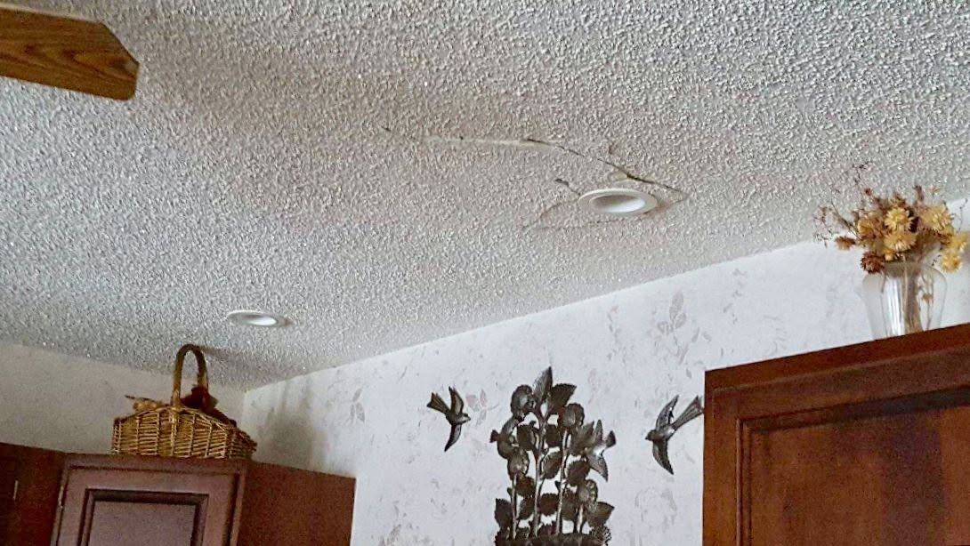 Cracked textured ceiling before the work