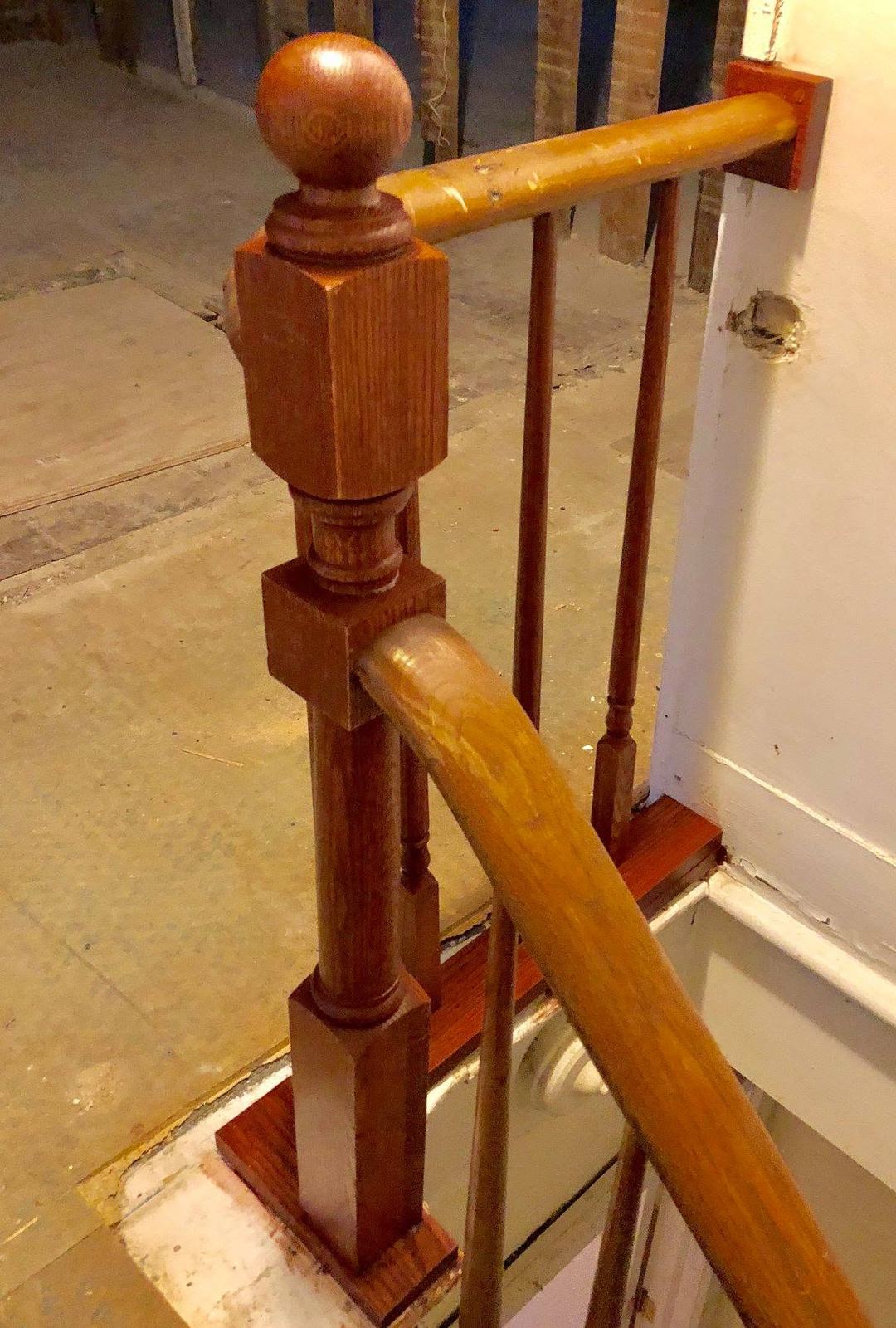 Square wood newel with a ball cap and curved handrail